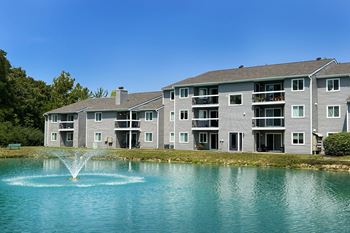 a fountain in a lake in front of an apartment building at Deercross Apartments, Cincinnati, 45236